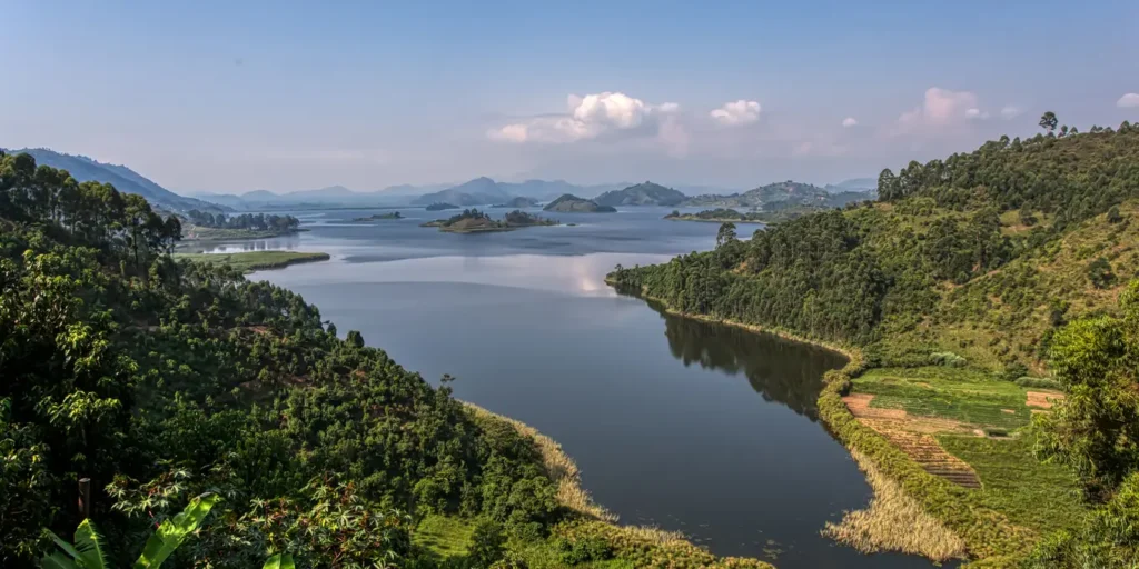 Hidden gems in Uganda: Lake Mutanda winding between green hills below the Virunga volcanoes