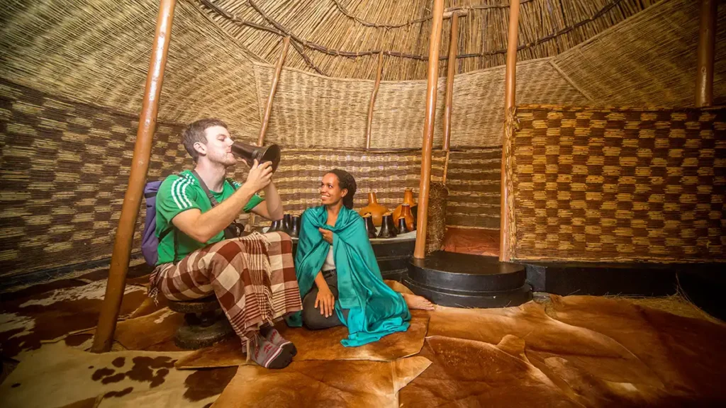 Visitors inside a traditional Ankole hut at the Igongo Cultural Centre near Mbarara