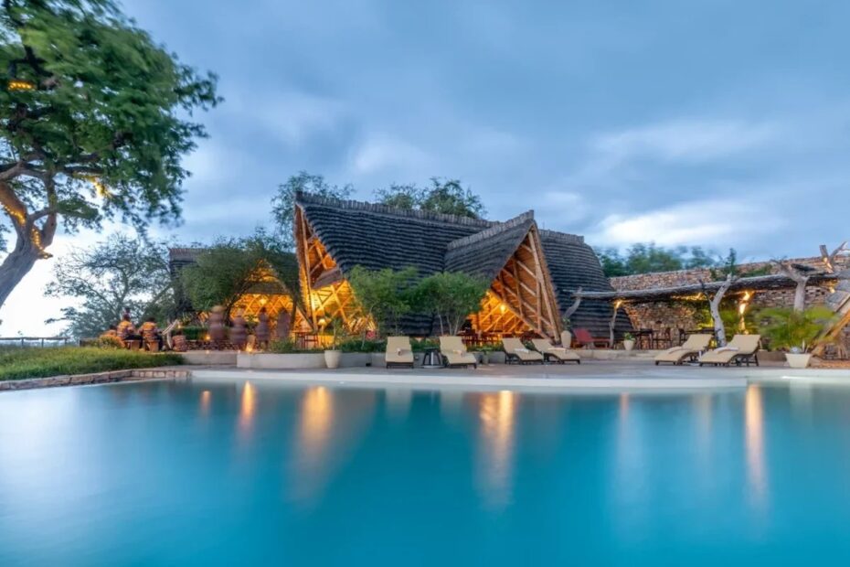 Lodges in Murchison Falls National Park: a safari lodge with a swimming pool at dusk