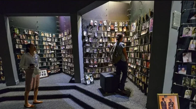 Rwanda National Parks: Complete Guide to the 4 Parks, Fees and Activities Visitors viewing the photo gallery of victims at the Kigali Genocide Memorial